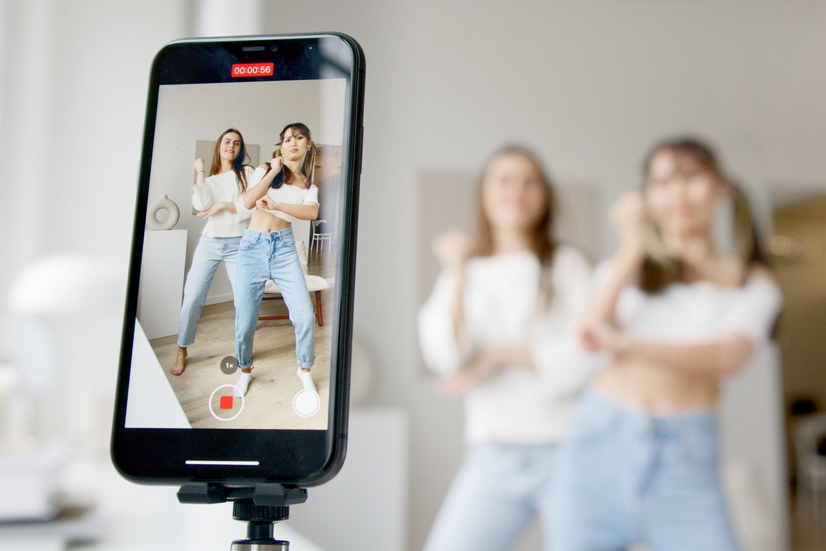 young women dancing in front of a camera