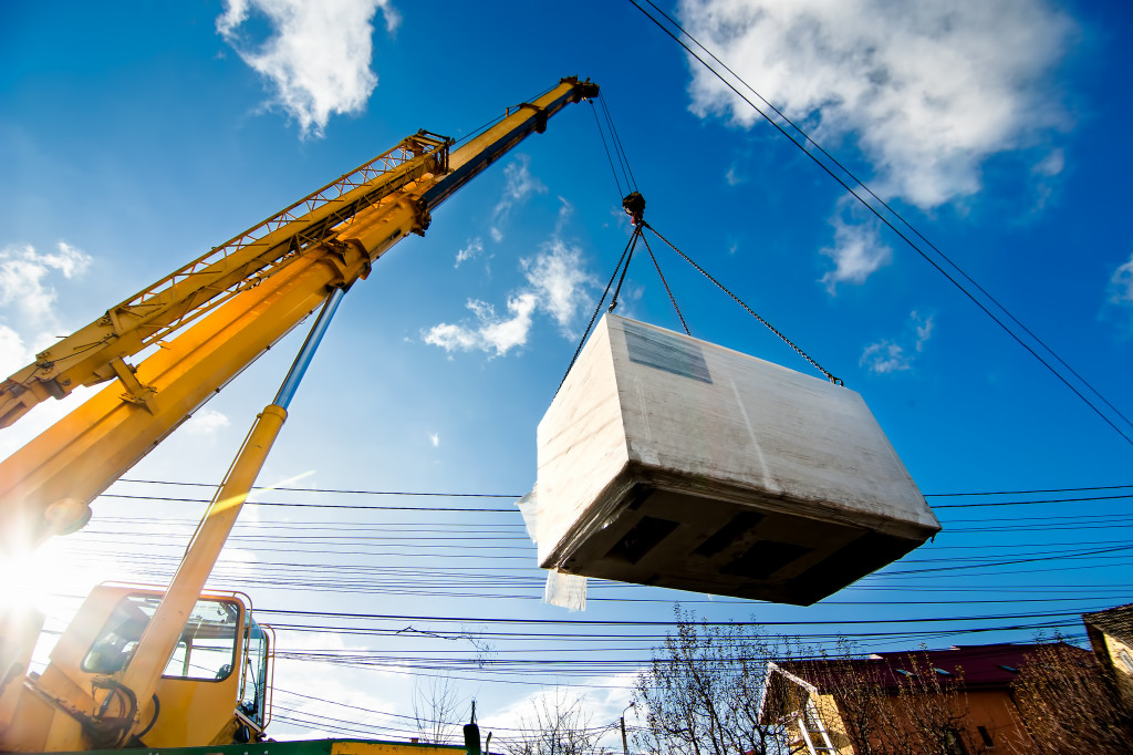 a large crane lifting a generator in a construction site