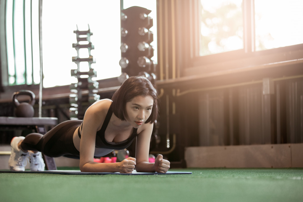 woman doing push-ups in makeshift gym at home