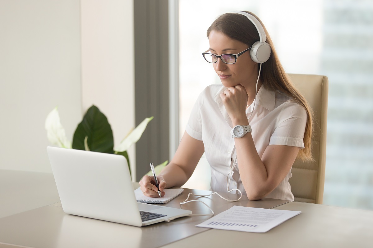 woman looking at her opened laptop